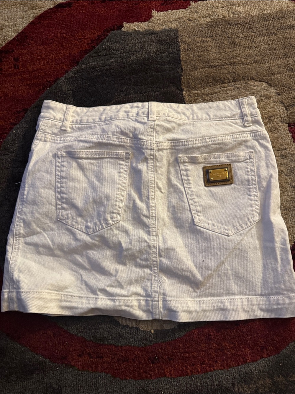 Dolce & Gabbana White Denim Mini Skirt with Gold Plaque